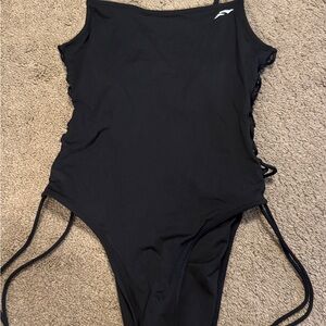 Flag Nor Fail Black Apparel one piece swim . With adjustable ties on the side .